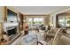 Cozy living room with a fireplace, large windows, and water view at 3602 Bay Rd S Dr, Indianapolis, IN 46240