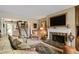Inviting living room with fireplace, staircase access, and large rug at 3602 Bay Rd S Dr, Indianapolis, IN 46240