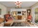 Elegant living room with a decorative chandelier, classic furniture, and an open layout to a naturally lit space at 3602 Bay Rd S Dr, Indianapolis, IN 46240