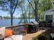 Enjoy serene lake views from this outdoor deck featuring comfortable seating, BBQ grill, and dining space at 3602 Bay Rd S Dr, Indianapolis, IN 46240