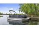 Side view of a sleek pontoon boat with comfortable seating, perfect for relaxing cruises on the water at 3602 Bay Rd S Dr, Indianapolis, IN 46240