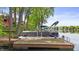 A view of a pontoon boat on the lake, featuring a wooden dock with a ladder for easy access at 3602 Bay Rd S Dr, Indianapolis, IN 46240