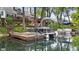 A beautiful view of pontoon boats docked on a tranquil lake surrounded by lush greenery and houses at 3602 Bay Rd S Dr, Indianapolis, IN 46240