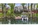 Charming waterfront property with a private dock and boat on the lake, surrounded by lush trees and landscaped greenery at 3602 Bay Rd S Dr, Indianapolis, IN 46240