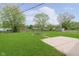 Expansive backyard featuring lush green grass, mature trees, and a trampoline at 3723 S Dearborn St, Indianapolis, IN 46237