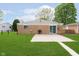 Large grassy backyard with brick house, small patio, grill and fence at 3723 S Dearborn St, Indianapolis, IN 46237