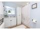 Bright bathroom featuring a white vanity, decorative shower curtain, and ample lighting at 3723 S Dearborn St, Indianapolis, IN 46237