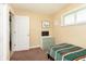Bright bedroom with a green striped bed, window, and matching dresser at 3723 S Dearborn St, Indianapolis, IN 46237