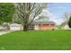 Charming brick ranch home featuring a well-maintained lawn and detached garage at 3723 S Dearborn St, Indianapolis, IN 46237