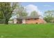 Charming brick ranch home with a lush green lawn and inviting front porch at 3723 S Dearborn St, Indianapolis, IN 46237