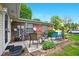 This brick back patio has multiple chairs and some shrubbery for privacy at 4505 Stratford Dr, Anderson, IN 46013