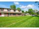 Inviting two-story townhouse with a well-maintained lawn and red shutters at 4505 Stratford Dr, Anderson, IN 46013