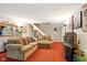 Comfortable living room featuring a large sectional sofa, stairs, and neutral decor at 4505 Stratford Dr, Anderson, IN 46013
