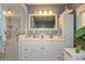 Bright bathroom with double sinks, white cabinetry, and a glass-enclosed shower at 455 E Main St, Danville, IN 46122