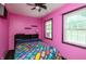 Unique bedroom featuring bright pink walls, a colorful comforter and natural light at 455 E Main St, Danville, IN 46122