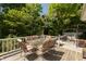 A multi-level wooden deck offers ample space for outdoor gatherings, complemented by comfortable seating arrangements and lush greenery at 455 E Main St, Danville, IN 46122