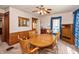 A formal dining room with a wood table, and chairs, with carpet flooring and blue curtains at 455 E Main St, Danville, IN 46122