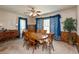 A formal dining room with a wood table, and chairs, with carpet flooring and blue curtains at 455 E Main St, Danville, IN 46122
