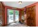 A warm entryway with access to the backyard deck, wooden doors, and neutral walls at 455 E Main St, Danville, IN 46122