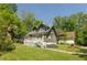 Charming home with mature trees, a green lawn, and a welcoming front porch at 455 E Main St, Danville, IN 46122