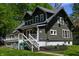 Charming home with a well-maintained lawn, inviting front porch, and lush, mature trees in a neighborhood setting at 455 E Main St, Danville, IN 46122