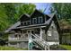 Charming home with a well-maintained lawn, inviting front porch, and lush, mature trees in a neighborhood setting at 455 E Main St, Danville, IN 46122