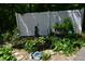 Charming garden featuring a small pond, a variety of plants and gravel landscaping at 455 E Main St, Danville, IN 46122