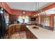 An eat-in kitchen features wood cabinets, black appliances, and ample counter space with a statement light fixture at 455 E Main St, Danville, IN 46122