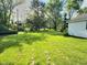 Lush green backyard showcasing a well-maintained lawn and mature trees, perfect for outdoor enjoyment at 4986 Adkins St, Columbus, IN 47201