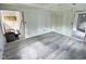 Large bedroom featuring modern gray flooring and fresh paint, ready for customization at 4986 Adkins St, Columbus, IN 47201