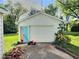 Detached garage featuring a lawn mower, fresh paint job, and ready for vehicle storage or a workshop at 4986 Adkins St, Columbus, IN 47201
