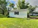 Garage exterior surrounded by a lush lawn, offering a practical space for parking and storage at 4986 Adkins St, Columbus, IN 47201