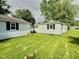 View of the detached garage and its lawn, offering ample space for outdoor activities at 4986 Adkins St, Columbus, IN 47201