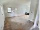 Bright living room featuring hardwood floors, windows, and an entryway door, ready for updates at 4986 Adkins St, Columbus, IN 47201