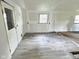 Spacious living room featuring new gray flooring, fresh paint, and great natural light at 4986 Adkins St, Columbus, IN 47201