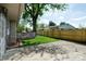 View of a well-maintained backyard with a new fence and concrete patio, perfect for entertaining at 506 S Green St, Brownsburg, IN 46112