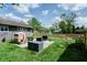 A cozy backyard featuring a patio with outdoor seating and a charming playhouse for children at 506 S Green St, Brownsburg, IN 46112