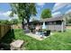 A serene backyard featuring a seating area on a lush lawn with mature trees at 506 S Green St, Brownsburg, IN 46112