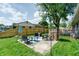 The backyard has a patio with seating area, playground and large shade tree at 506 S Green St, Brownsburg, IN 46112