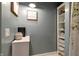 Bathroom area featuring a pedestal sink, built in storage, tile floors, and a decorative theme at 506 S Green St, Brownsburg, IN 46112