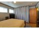 Bedroom with wood floors, two windows, and a closet with a neutral curtain at 506 S Green St, Brownsburg, IN 46112