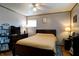 Bedroom featuring wood-framed bed, ceiling fan, wood flooring, and two dressers at 506 S Green St, Brownsburg, IN 46112