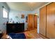 Cozy bedroom with dark wood dresser and closet, light blue walls, and a window at 506 S Green St, Brownsburg, IN 46112