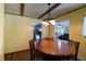 Cozy dining area features a wood table, chairs, and chandelier with views into kitchen and living room at 506 S Green St, Brownsburg, IN 46112