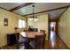 Inviting dining room with a wooden table, a pendant light, and hardwood floors at 506 S Green St, Brownsburg, IN 46112