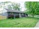 Charming single-story home features a landscaped front yard, neutral siding, and a cozy front porch at 506 S Green St, Brownsburg, IN 46112
