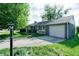 Well-maintained home features neutral siding, an attached garage, and a lamp post at 506 S Green St, Brownsburg, IN 46112