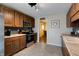 This kitchen features wood cabinets, stainless steel appliances, tile floors, and a view into the dining room at 506 S Green St, Brownsburg, IN 46112
