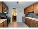 This kitchen features wood cabinets, stainless steel appliances, tile floors, and a view into the dining room at 506 S Green St, Brownsburg, IN 46112
