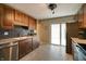 Bright kitchen features stainless steel appliances, granite countertops, and subway tile backsplash, with a sliding glass door to outside at 506 S Green St, Brownsburg, IN 46112